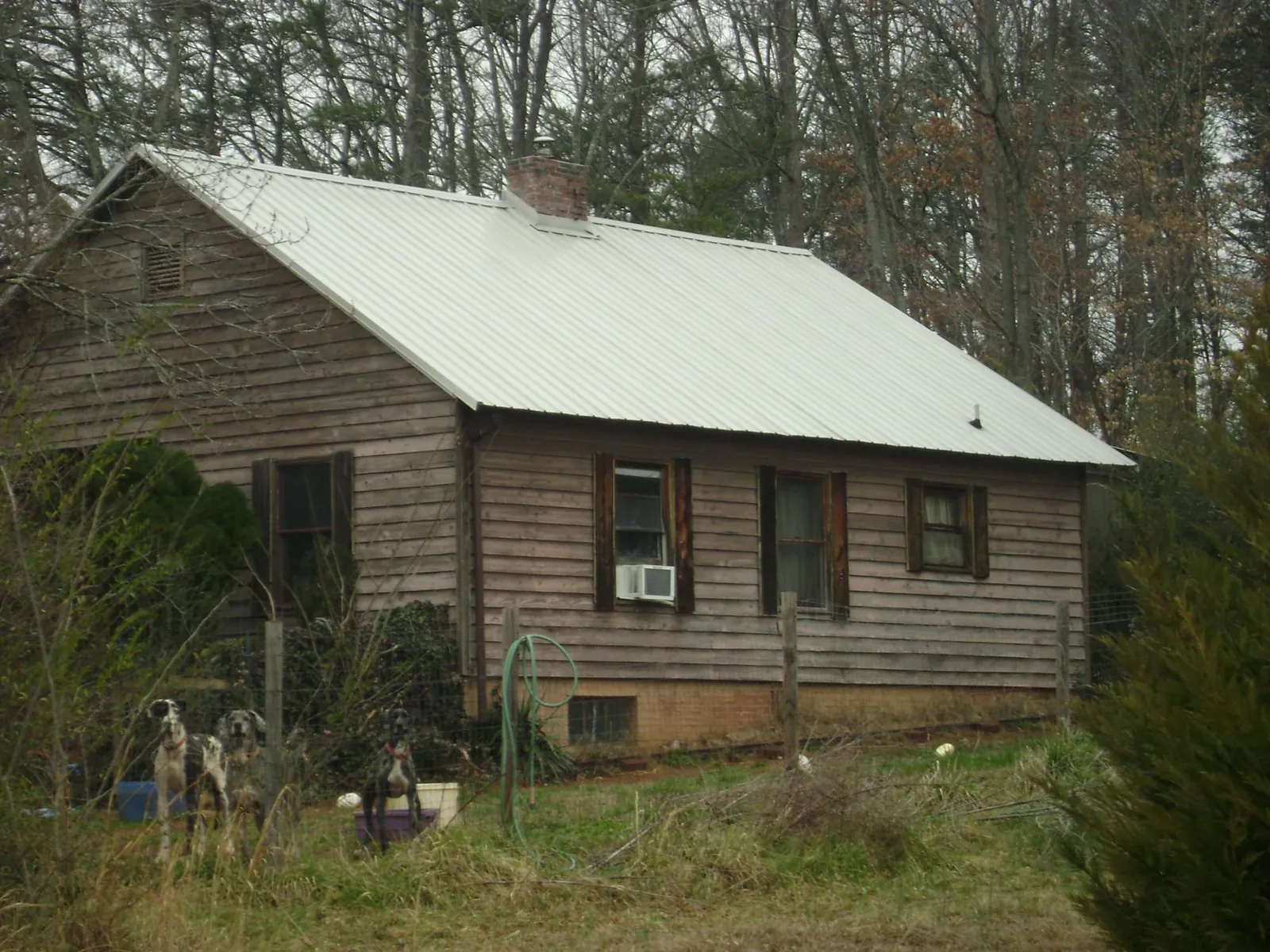 White metal roof on an old wood sided farmhouse, from a Metal Roof Installation job in Rumney